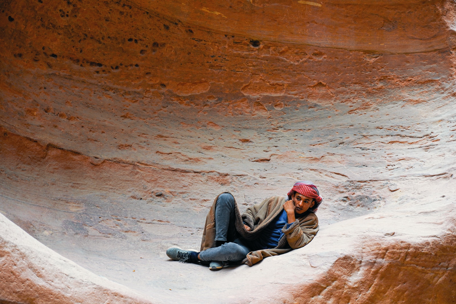 a person laying on the ground in a canyon